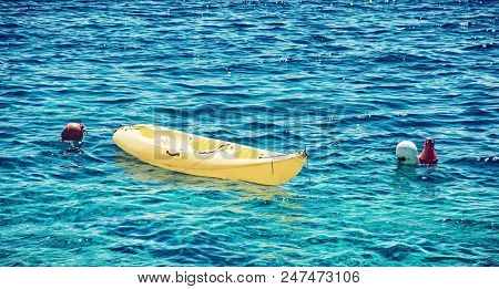 Anchored Yellow Kayak In Maslinica, Solta Island, Croatia. Summer Vacation Destination. Beauty Photo