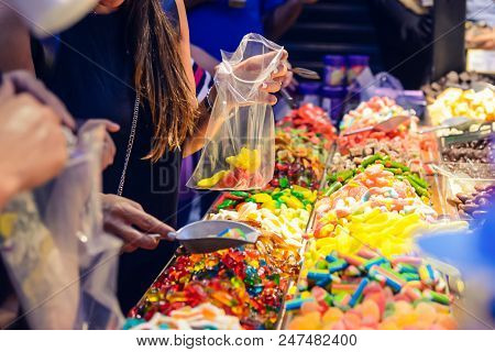 Customers Choose Sweets From Counter With Assorted Colorful Different Shape Jelly Candies On Market 