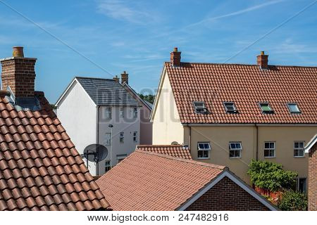 Modern Suburban Crowded Housing Estate Buildings. Urban House Roof Tops. View Of A Variety Of Contem