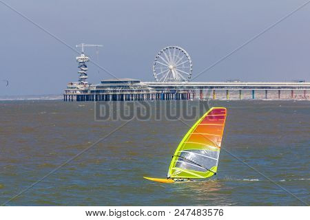 Scheveningen, The Hague, The Netherlands - June 27 2018: Speeding Windsurfers Sailing Off The Beach 