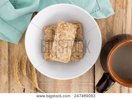 Wheat Biscuit Breakfast Cereal Raw In Bowl On Rustic Wooden Table - Top View Photograph