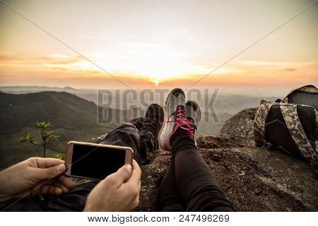 Couple Taking Picture On Mountain Top After Climbing