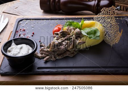 Beef Stroganoff Served With Mashed Potato On A Board