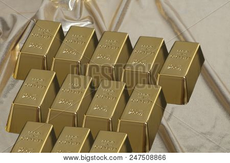Stacked Bars Of Gold Bullion On Golden Brocade Fabric.financial Concept