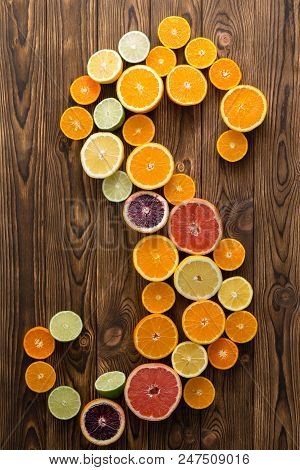 Juicy Healthy Ripe Halved Citrus Fruit In An S-shape On A Wooden Background With Decorative Woodgrai