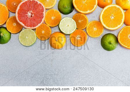 Mixed Still Life Border Of Colorful Fresh Cut Citrus Fruit With Oranges, Grapefruit, Clementine, Lim