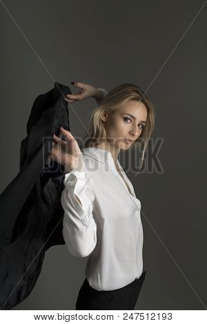 Portrait Of Blonde Girl In Jacket And White Shirt. Girl Throws A Jacket On Her Shoulders. Business P