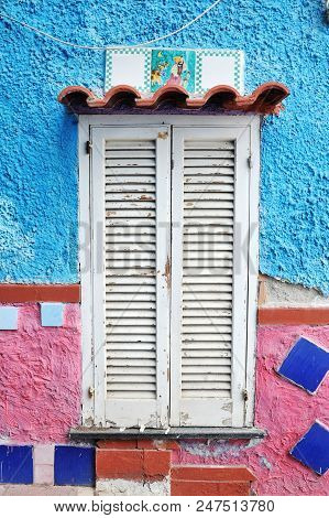 Vietri Sul Mare, Italy - April 27, 2018 Ancient Window Of Colored House, With Traditional Ceramics D