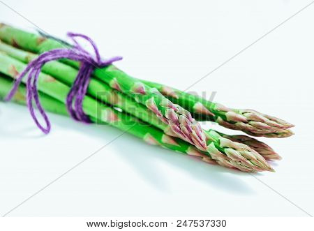 Fresh Green Asparagus Sprout Tops, Tied With A Thread. A Bound Bunch Of Three Asparagus Stems, Isola