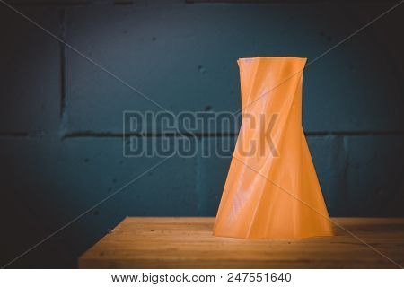 Bright Red Object Vase Printed By 3d Printer On Blue Brick Wall Background. Automatic Three Dimensio