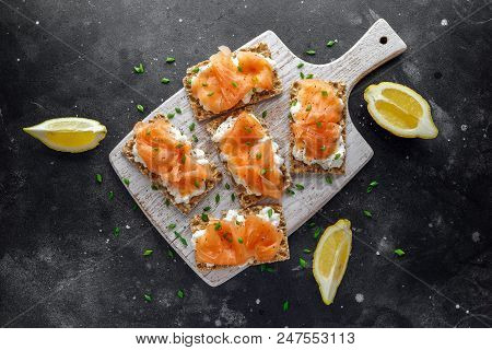 Homemade Crispbread Toast With Smoked Salmon And Soft Chees, Chives On White Board.