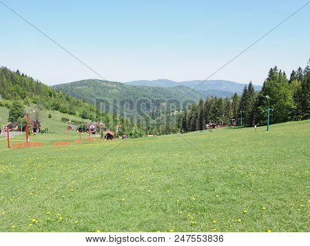 Great Landscapes Of Grassy Field And Forest At Beskid Mountains Range In European Salmopol Pass At B