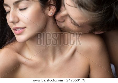Close Up Of Loving Passionate Man Kissing Beautiful Young Woman On Neck, Pleasing Her And Stimulatin