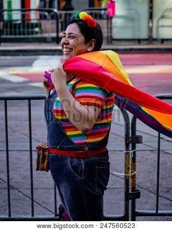 Gay Pride Parade In San Francisco - Woman Wears Rainbow Shirt And Cape In Support