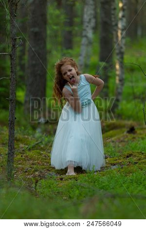 Little Emotional Girl Walks In A Summer Forest In A Dress