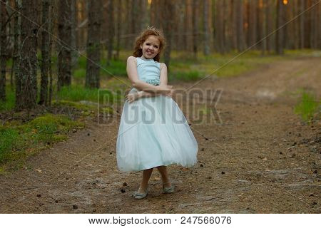 Little Emotional Girl Walks In A Summer Forest In A Dress