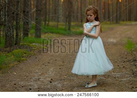 Little Emotional Girl Walks In A Summer Forest In A Dress