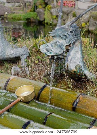Yamanashi, Japan - September 26, 2017 : Spring Water From Dragon Ornament Tap Of Waku Pond Is One Of