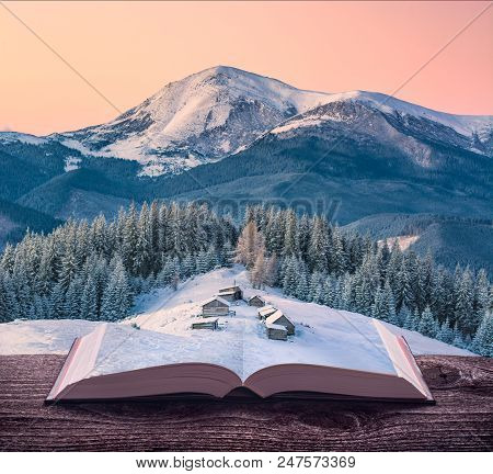 Miniature Alpine Mountain Village At Winter On The Pages Of An Open Magical Book. Majestic Landscape