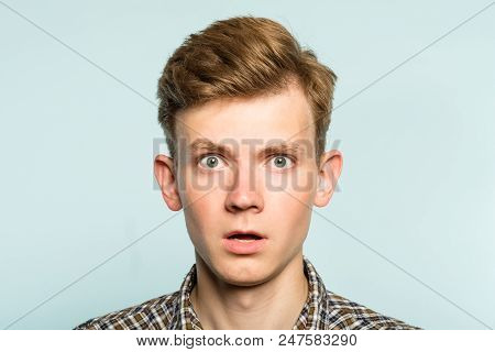 Shocked Speechless Dumbstruck Man With Open Mouth. Portrait Of A Young Guy On Light Background. Emot