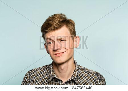 Doubtful Man Raising Eyebrow Ironically. Stuck Up Mockery. Portrait Of A Young Guy On Light Backgrou
