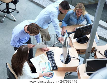 Top View Of Young Modern Colleagues In Smart Casual Wear Working Together While Spending Time In The