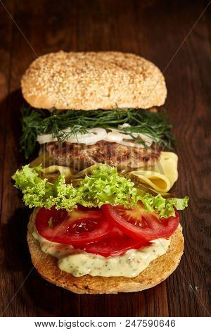 Close-up Of Delicious Fresh Home Made Burger With Piccoli, Lettuce, Cheese, Onion, Tomato, Dill And 