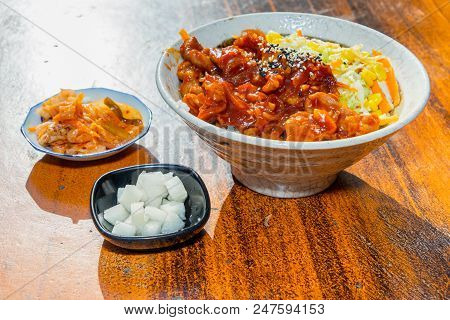 Korean Stir Fried Chicken Rice In White Bowl On Wooden Able