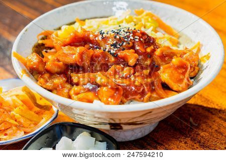 Korean Stir Fried Chicken Rice In White Bowl On Wooden Able