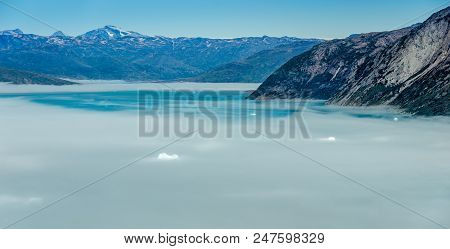 Mist Over Icebergs In A Sunny Day Near Narsarsuaq