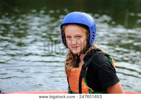 Young Teenager Girl Actively Manages A Sports Kayak Boat On A Beautiful River