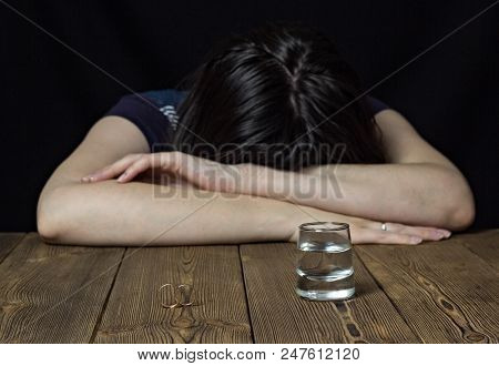 Drunk Girl And Alcohol On A Wooden Background, Wedding Rings On A Table, Divorce Marriage