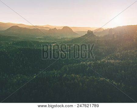 Beautiful Misty Sunrise In Toned Picture . Autumn Hilly Landscape Covered With Shinning Fog.  Sharp 