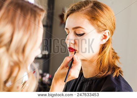 Hand Of Make-up Master, Painting Lips Of Young Beauty Model Girl