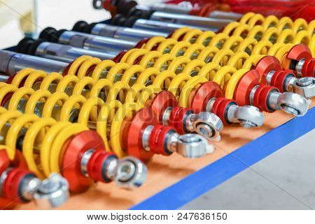 A Row Of Red Shock Absorbers For Car