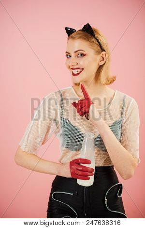 Sexy Catwoman. Female With Cat Makeup And Ears. Drinking Milk Brom The Bottle