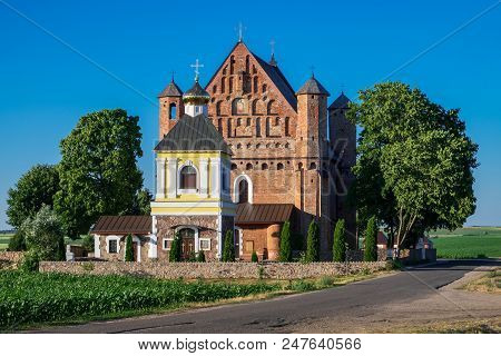 Old 15th Century St. Michael Fortified Church And Bell Tower In Synkovichy Village, Grodno Region, B