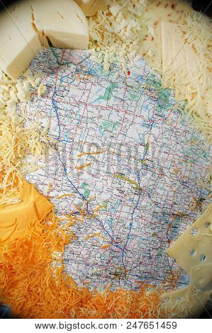 An Array Of Cheeses Pictured With A Map Of Wisconsin.