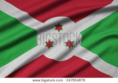 Burundi Flag  Is Depicted On A Sports Cloth Fabric With Many Folds. Sport Team Waving Banner