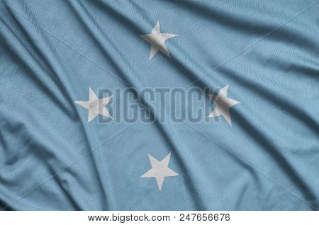 Micronesia Flag  Is Depicted On A Sports Cloth Fabric With Many Folds. Sport Team Waving Banner
