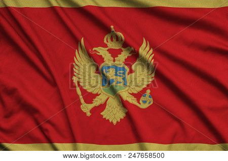 Montenegro Flag  Is Depicted On A Sports Cloth Fabric With Many Folds. Sport Team Waving Banner