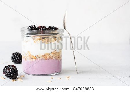Yogurt Parfait With Blackberries And Granola In A Jar. Healthy Breakfast, Overnight Oats Or Snack. C