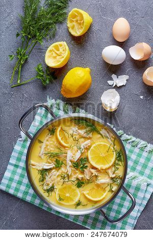 Avgolemono - Delicious Creamy Greek Chicken Soup With Lemon, Egg Yolk, Pasta Risini And Herbs In A C