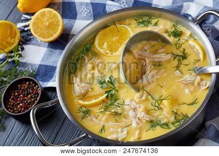 Avgolemono - Delicious Creamy Greek Chicken Soup With Lemon, Egg Yolk, Pasta Risini And Herbs In A C