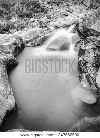 Multiple Waterfalls On River Brittle  With Many Cold Swimmable Pools. Black And White Photography