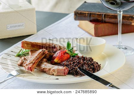 Appetizing Dish In A Restaurant: Juicy Mutton Ribs Of Medium Rare With Brown Rice, Strawberry And Sa