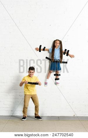 Brother Glued Sister To Wall With Black Tape At Home