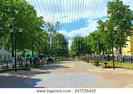 Gomel / Belarus - May 20, 2018 : Street Of Belarusian City Of Gomel With Benches Trees And Hanging G