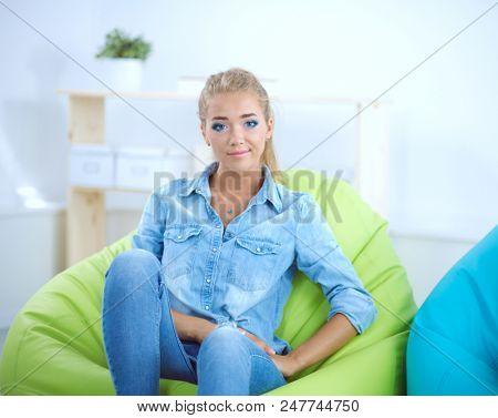 Attractive woman sitting on chair at home