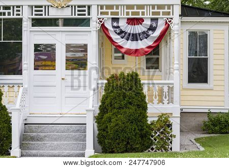 Exterior And Front Door Of A Beautiful Old House With Banting Flag In New Hampshire, Usa